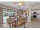 Warm dining area features a rustic table with seating, flowing to kitchen, perfect for gathering and creating memories at 10305 E Plata Ave, Mesa, AZ 85212