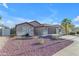 Well-maintained single-story home with a manicured front yard, desert landscaping, and two-car garage at 10305 E Plata Ave, Mesa, AZ 85212