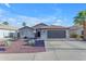 Beautiful single-story home with a two-car garage, desert landscaping, and a welcoming facade at 10305 E Plata Ave, Mesa, AZ 85212