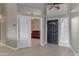 Bright foyer featuring tile flooring, a black front door, and an open doorway leading to a living space at 10305 E Plata Ave, Mesa, AZ 85212