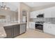 Updated kitchen with granite countertops, stainless steel appliances, and tile flooring at 10305 E Plata Ave, Mesa, AZ 85212