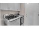 The laundry area includes front-loading washer and dryer, white cabinets, and access to the service door at 10305 E Plata Ave, Mesa, AZ 85212