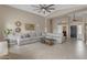 Spacious living room features tile floors, a ceiling fan, and neutral tones, creating a cozy atmosphere at 10305 E Plata Ave, Mesa, AZ 85212