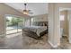 Bright main bedroom with a sliding glass door leading to the backyard pool at 10305 E Plata Ave, Mesa, AZ 85212