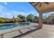 A private outdoor pool area, featuring a well-maintained pool with an umbrella and multiple lounge chairs at 10305 E Plata Ave, Mesa, AZ 85212