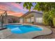 Backyard pool with covered patio and desert landscape, perfect for outdoor entertaining at 10305 E Plata Ave, Mesa, AZ 85212