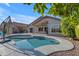 Backyard pool is surrounded by desert landscaping, offering a private retreat at 10305 E Plata Ave, Mesa, AZ 85212