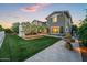 Expansive backyard featuring a lush lawn, an outdoor living area, and elegant landscaping with mature trees at 10344 E Trillium Ave, Mesa, AZ 85212