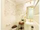 Elegant powder room featuring marble accents, an antique table, and wainscoting detail at 10344 E Trillium Ave, Mesa, AZ 85212