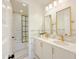 Bathroom highlighting dual sinks, gold fixtures, and a tiled shower and tub for a spa-like experience at 10344 E Trillium Ave, Mesa, AZ 85212