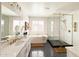 Bright bathroom showcasing a freestanding tub, glass-enclosed shower, and modern black and white patterned floor at 10344 E Trillium Ave, Mesa, AZ 85212