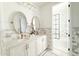 Bright bathroom featuring marble countertops, double sinks, gold hardware, and a glass-enclosed shower at 10344 E Trillium Ave, Mesa, AZ 85212