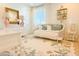 Bedroom featuring a decorative daybed, desk, and floral rug, perfect for a guest room at 10344 E Trillium Ave, Mesa, AZ 85212