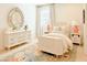 Charming bedroom with decorative rug, dresser, oval mirror, bedside tables, and matching lamps at 10344 E Trillium Ave, Mesa, AZ 85212