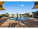 Well-maintained community pool with ample seating and shade structures, offering a perfect place for recreation at 10344 E Trillium Ave, Mesa, AZ 85212