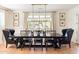 Elegant dining room with a large table, black chairs, and a chandelier overhead at 10344 E Trillium Ave, Mesa, AZ 85212