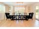 Formal dining room with a modern chandelier, wainscoting, shuttered windows, and seating for eight at 10344 E Trillium Ave, Mesa, AZ 85212