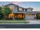 Inviting two-story home with well-maintained landscaping, covered porch, and attached garage at 10344 E Trillium Ave, Mesa, AZ 85212