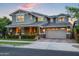 Beautiful two-story home featuring a manicured lawn and a spacious two-car garage at 10344 E Trillium Ave, Mesa, AZ 85212
