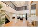 Spacious foyer with high ceilings, a grand chandelier, staircase, and views into the dining and living areas at 10344 E Trillium Ave, Mesa, AZ 85212