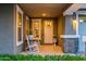 Charming front porch featuring rocking chairs, stone accents, and a welcoming entrance at 10344 E Trillium Ave, Mesa, AZ 85212