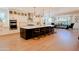 Open-concept kitchen showcasing a large island, modern cabinetry, and views into the dining area at 10344 E Trillium Ave, Mesa, AZ 85212