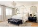 Bright main bedroom featuring a four-poster bed, chandelier, hardwood floors, and elegant decor at 10344 E Trillium Ave, Mesa, AZ 85212