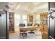 Charming office space with wooden bookshelves, a desk, and comfortable seating at 10344 E Trillium Ave, Mesa, AZ 85212