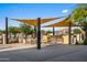 Outdoor dining area featuring BBQ grills, ample seating, and protective shade canopies at 10344 E Trillium Ave, Mesa, AZ 85212