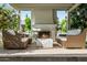 Inviting outdoor fireplace with wicker furniture creates a perfect spot to enjoy the serene backyard setting at 10344 E Trillium Ave, Mesa, AZ 85212