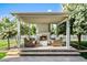 Cozy outdoor fireplace with comfortable seating, perfect for relaxing and enjoying the serene backyard setting at 10344 E Trillium Ave, Mesa, AZ 85212