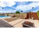 Private backyard features a pool, fire pit, landscaped areas, and block fence for outdoor enjoyment at 1062 E Watson Dr, Tempe, AZ 85283