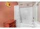 This bathroom features a shower-tub combo and peach accent wall paint at 1062 E Watson Dr, Tempe, AZ 85283