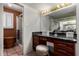 Bathroom vanity with marble countertop, adjacent glass enclosed shower and ample storage space at 1062 E Watson Dr, Tempe, AZ 85283