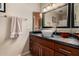 Charming bathroom featuring a granite countertop, vanity, decorative mirrors, and modern fixtures at 1062 E Watson Dr, Tempe, AZ 85283