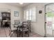 Bright dining area features a glass table set, and shuttered windows for natural lighting at 1062 E Watson Dr, Tempe, AZ 85283