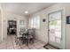 Bright dining area features a glass table set, shuttered windows and a door leading to the outside at 1062 E Watson Dr, Tempe, AZ 85283