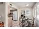 Bright dining area with a glass table and pink tile flooring adjoins kitchen and living room spaces at 1062 E Watson Dr, Tempe, AZ 85283