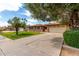 Attractive one-story brick house with lush green lawn, mature trees, and an attached garage at 1062 E Watson Dr, Tempe, AZ 85283