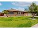 Attractive one-story brick house with lush green lawn, mature trees, and an attached garage at 1062 E Watson Dr, Tempe, AZ 85283