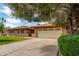 Attractive one-story brick house with lush green lawn, mature trees, and an attached garage at 1062 E Watson Dr, Tempe, AZ 85283