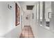 Bright hallway with neutral walls, and decorative mirror adds depth to the home's interior at 1062 E Watson Dr, Tempe, AZ 85283