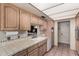 Efficient kitchen features wooden cabinets, tiled countertops, and ample storage space at 1062 E Watson Dr, Tempe, AZ 85283