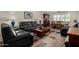 Traditional living room featuring black leather sofas, a wooden coffee table, and tile flooring at 1062 E Watson Dr, Tempe, AZ 85283