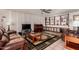 Spacious living room with decorative shelving, wood-look accent wall, and a piano at 1062 E Watson Dr, Tempe, AZ 85283