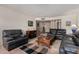 Cozy living room with comfortable leather seating, neutral walls, and tile flooring at 1062 E Watson Dr, Tempe, AZ 85283