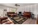 Living room with wood-look accent wall and a brown leather sofa at 1062 E Watson Dr, Tempe, AZ 85283