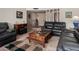 Cozy living room with comfortable leather seating, neutral walls, and tile flooring at 1062 E Watson Dr, Tempe, AZ 85283
