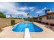 Refreshing pool with diving board, surrounded by a patio, provides a perfect retreat at 1062 E Watson Dr, Tempe, AZ 85283