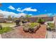 A well-maintained backyard with a brick perimeter, raised garden beds, a swing bench and a barbecue grill at 10755 W Mountain View Dr, Avondale, AZ 85323